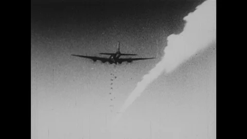 1940s: Planes drop bombs onto towns. Bombs explode on ground. Artillery cannons Video stock 126014807