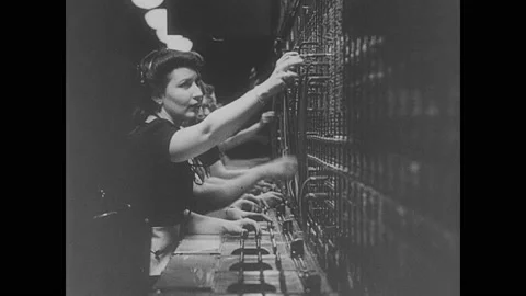 1940s: Planes fly overhead.  Crowd watches.  Man talks on phone.  Switchboard Vídeos de archivo 142235536