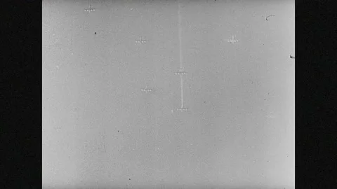 1940s: Planes fly in sky. Large guns shoot into sky. Bombs explode on ground. Vídeos de archivo 133665299