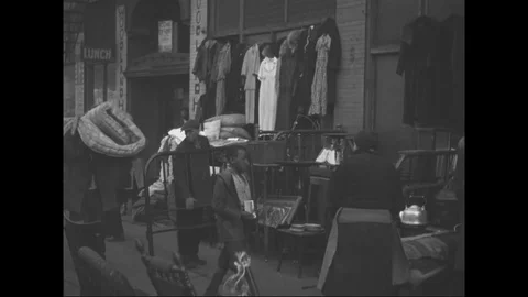 1940s - Poor black and white families take bedding from a Cleveland alley. Stock Footage 126050720