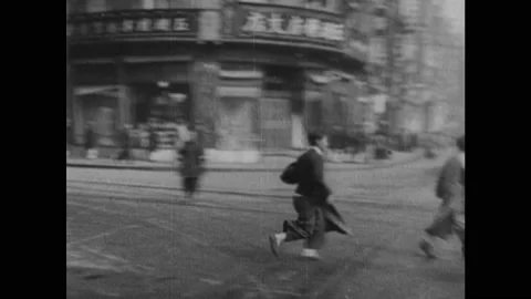 1940s: Ship cannon fires. Bombs explode. People run through city in a panic. Stock Footage 140893390