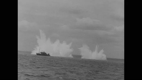 1940s: Ships fire weapons. Man flashes light from on board ship. Soldiers climb Stock Footage 150349345