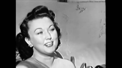 1940s - Singer Ginny Simms concludes a performance of "I Don't Stand a Ghost of Video stock 246365051