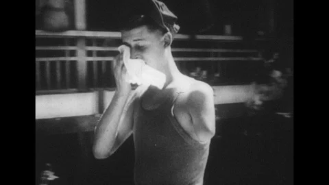 1940s: Soldier with missing arm walks past camera / Views of soldiers carrying Stock Footage