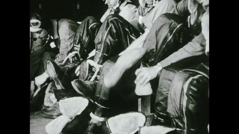 1940s: Soldiers pull on boots, man zips up shearling aviator jacket. Steel Video stock 102697842