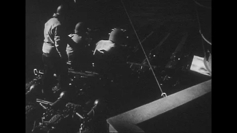 1940s: Soldiers with ship guns / Low angle view of guns / Radar ship / Close up Stock Footage