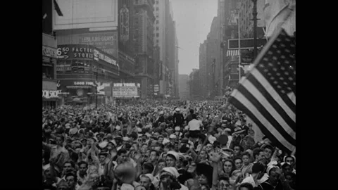 1940s: Streets full of celebrating people. Crowds waving American flags. Sailor Stock Footage