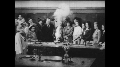 1940s: Teacher does science experiment. Teacher does demonstration in shop Stock Footage 121815637