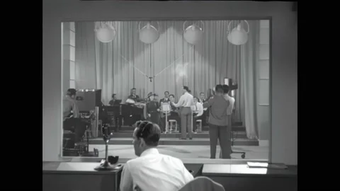 1940s: Television production studio, band sets up to play on broadcast. Woman Stock Footage