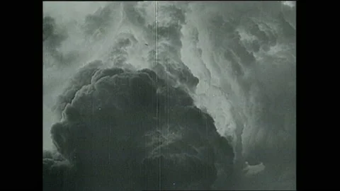 1940s: Test observers watch atomic bomb through tinted glass. After explosion, Stock Footage 153554610