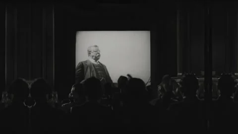 1940s: Theater audience clapping. President Theodore Roosevelt on projection Stock Footage