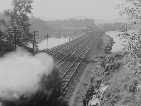 1940s: Train on land bridge over river Stock Footage 158175193