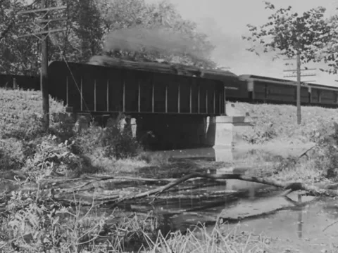 1940s: Train passes over river Stock Footage 158175180