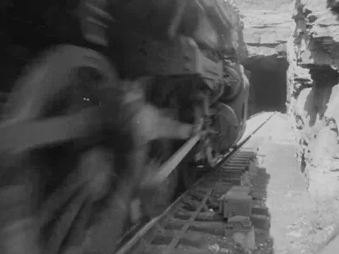 1940s: Train into rock tunnel Stock Footage 158174634