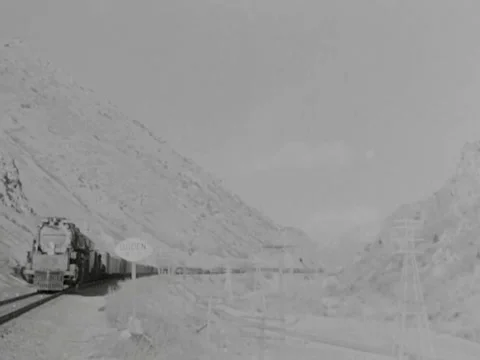 1940s: Train through mountain pass Video stock 231184680