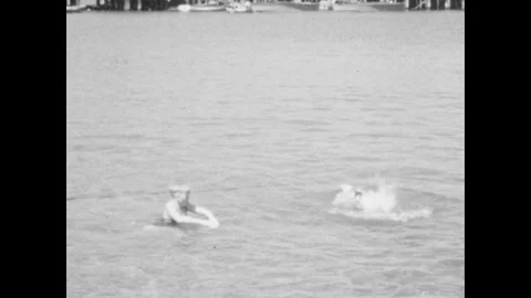 1940s: Two boys swim. Two boys swim sync... | Stock Video | Pond5