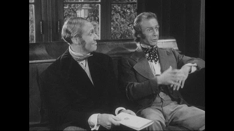 1940s: Two men sit on couch, talk. Stock Footage 90828024