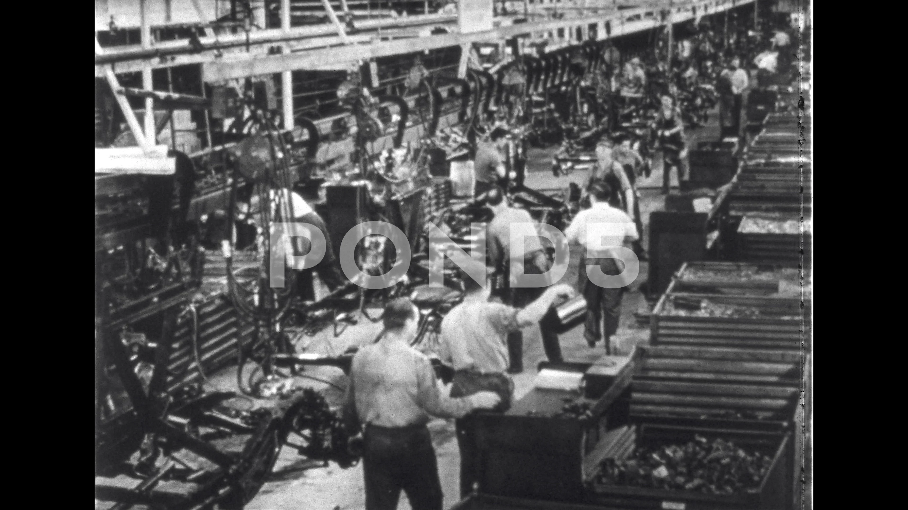 1940s: UNITED STATES: Chevrolet workers in factory. Chevrolet parts in