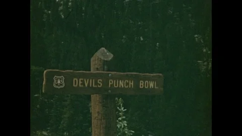 1940s: UNITED STATES: Devil's Punch Bowl sign. River runs through gorge. Video stock 85360779
