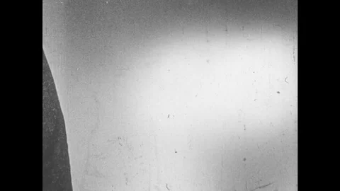 1940s: UNITED STATES: hand holds fire bomb. Incendiary device. Bomb explodes in Video stock 81931753