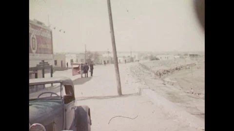 1940s: UNITED STATES: view across Old Mexico from car window. Cars stop at Stock Footage