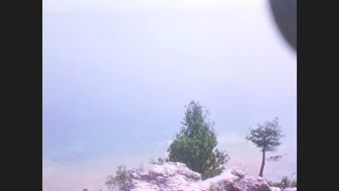 1940s: View of the coast of Mackinac Island, Michigan. A man and a boy stand at Stock Footage