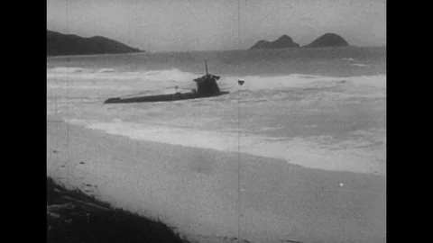 1940s: Views of beached submarine / Rescue vehicles by destroyed planes. Stock Footage