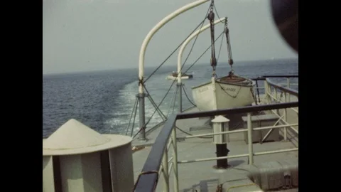 1940s: Views from deck of ferry boat, passing shoreline, boats in bay. Stock Footage 106626218