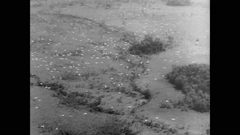 1940s: War planes fly over Japan. Parachutes and a church on New Guinea. Three Stockbeeldmateriaal 158437094