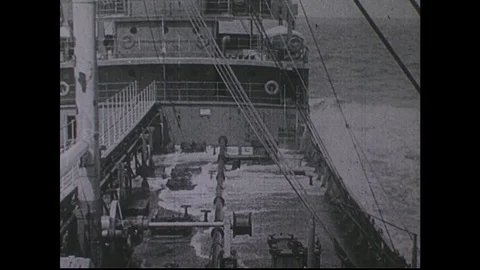 1940s: Waves crash on ship deck, fade out / Tank truck pulls up to gas station. Stock Footage 74909505