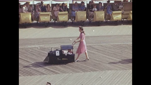 1940s: Woman pushes train float in parade. Women push and pull strollers and Stock Footage 82279628