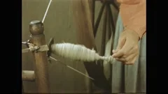 A woman making yarn from wool on a foot , Stock Video
