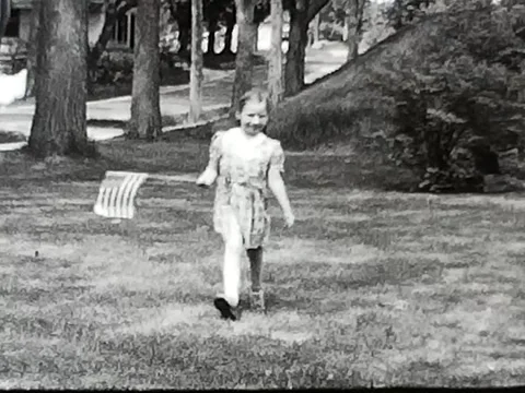 1940's Young girl Polio survivor with American flag Stock Footage
