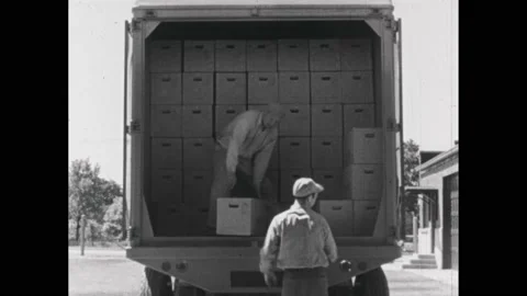 1940s:Men sort boxes of eggs into back of truck. Truck drives away from egg farm 스톡 동영상 231422775