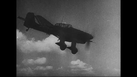 1941 - A dive bomber is shown and an animated map shows the conquest of Stock Footage 86407300