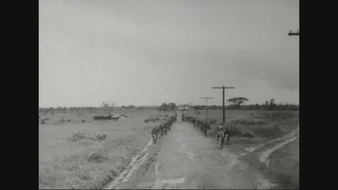 1941 - Soldiers fire at attacking warplanes and Filipino troops cross a river Stock Footage 82714161