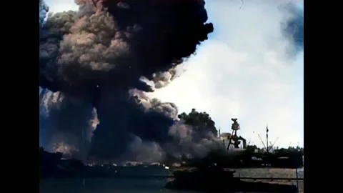 1941 - Thick black smoke rises from ships bombed in the Pearl Harbor attack. Stock Footage 234546806