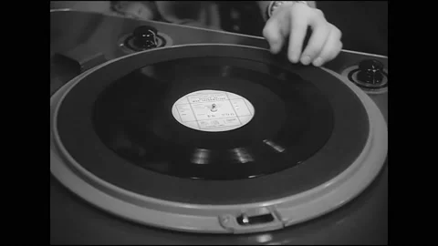 1942 - A man puts a record of a translated FDR speech onto a phonograph and Stock Footage 191047078