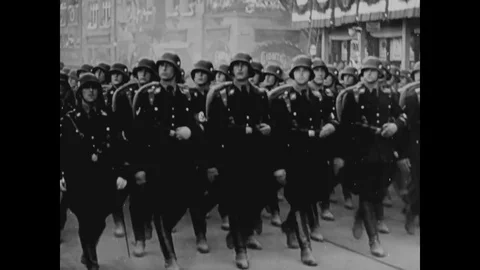 1942 - Military troops march through Italy and Germany, under Fascist or Nazi Stock Footage