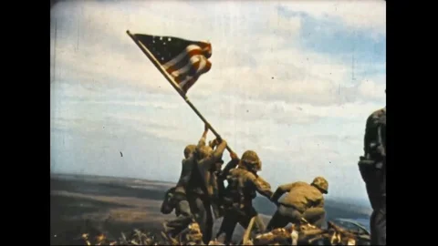 1942 Pacific War - Rising of Flag on Iwo Jima Island by US soldiers Stock Footage