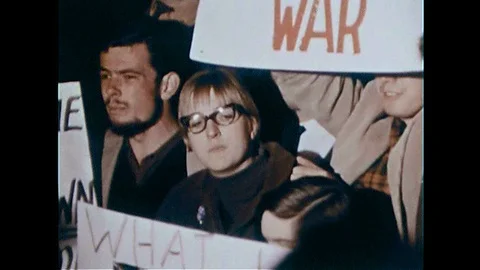 1943, 1966,  A group of Vietnam war protesters protest Lyndon Johnson in Stock Footage