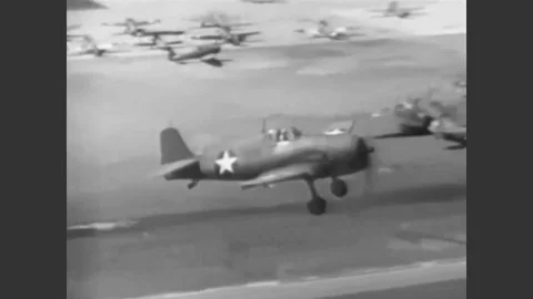 1943 - An F6F Hellcat comes in for a smooth landing on an air base. Stock Footage 90439213