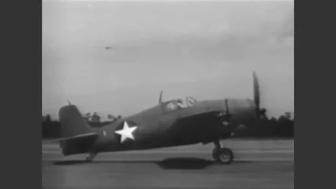 1943 - An F6F Hellcat pilot goes through his final checklist before takeoff. Stock Footage 90467151