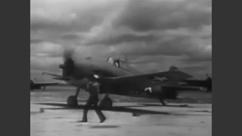 1943 - Once on the ground, a Navy pilot cuts his engine and demonstrates what Stock Footage 90439220