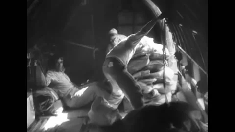 1943 - US Army Air Force C-47s drop supplies by parachute to a jungle base in Stock Footage 159147282