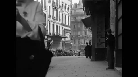 1944 - After sniper fire during the victory parade in Paris men are climbing Stock Footage 234539071