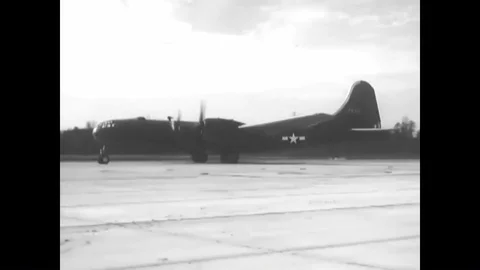 1944 - A B-29 pilot prepares the engines for flight while the flight engineer Stock Footage 90403908