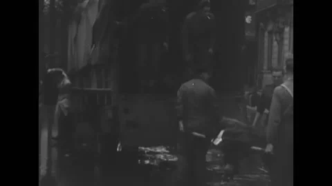 1944 - British soldiers pull the burned bodies of civilians out of wreckage in Stock Footage 164453810