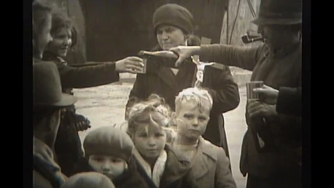 1944 - Italian refugees waiting for processing share a drink together. Stock Footage 101700366