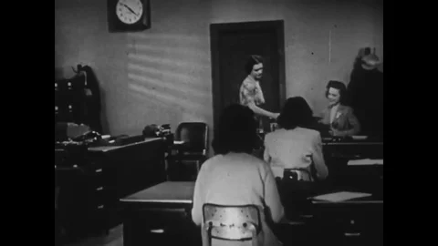 1944 - Secretaries file and sort papers and type documents in an office and a Stock Footage 79452482